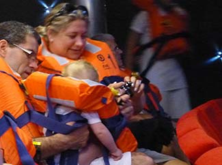 Couple with child and infant life jacket