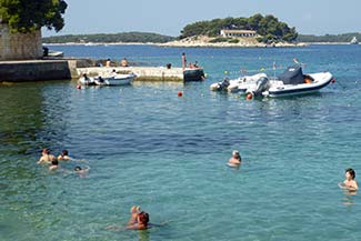 Hvar waterfront with swimmers