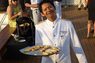 Smiling waiter on L'Austral