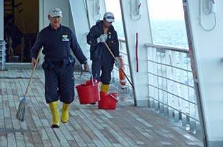 Sailors washing deck on Costa Magica