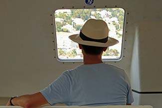 Man in hat on L'Austral tender