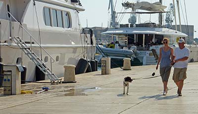 Couple with dog on Trogir waterfront