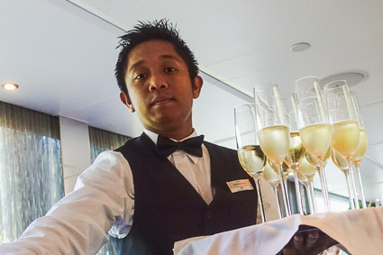 Waiter serving Champagne on EMERALD STAR