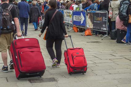 Tourists with suitcases in Venice