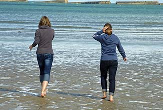 Young women on beach an Arromanches