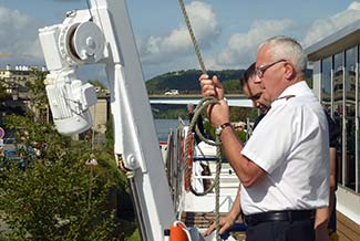 Captain raising gangway on RIVER BARONESS