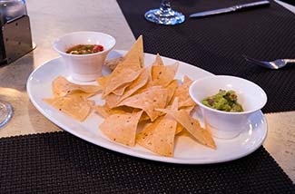 Tortilla chips, salsa, and guacamole in the Grill on Silver Spirit