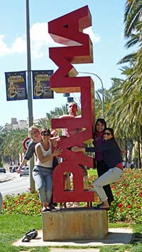 Tourists by Palma sign in Palma de Mallorca