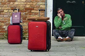 Man with luggage in Venice