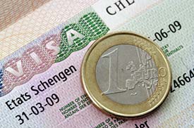 Schengen visa and euro coin