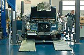 Mechanics and sedan at Mercedez-Benz Classic Center Fellbach