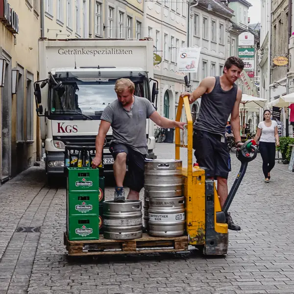 Delivery men bring beer to a bar in Bamberg, Germany.