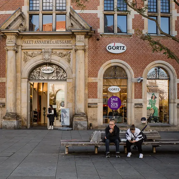 Shoppers share a bench on the Anger in downtown Erfurt, Germany.