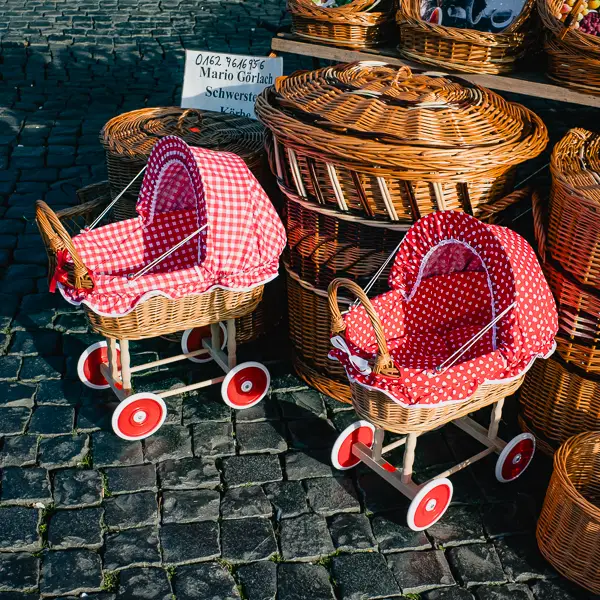  A basket vendor displays wicker baby carriages at a street market in Thuringia.