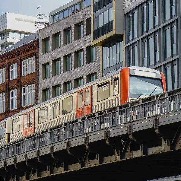 An elevated S-Bahn train speeds through central Hamburg, Germany.