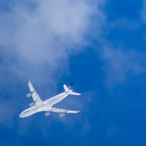 A four-engine airliner flies over Koblenz, Germany.