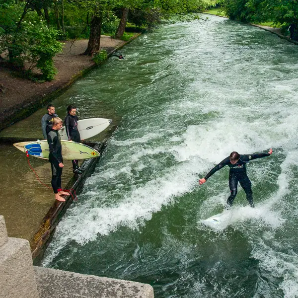 Surfers brave the Eisbachwelle in central Munich.