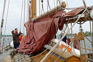 Passengers help with the sails on the FRANZIUS