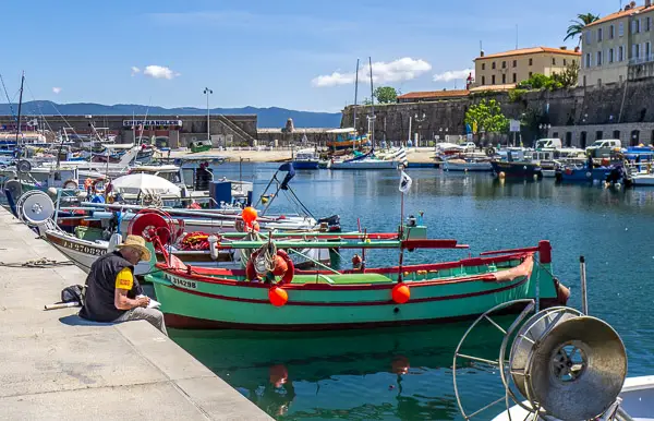 Man on seawall in Ajaccio, Corsica, France.