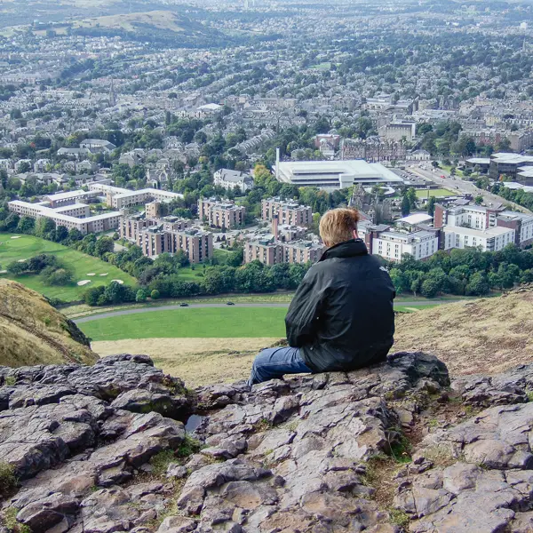 A man enjoys a view of Edinburgh from Arthur's Seat.