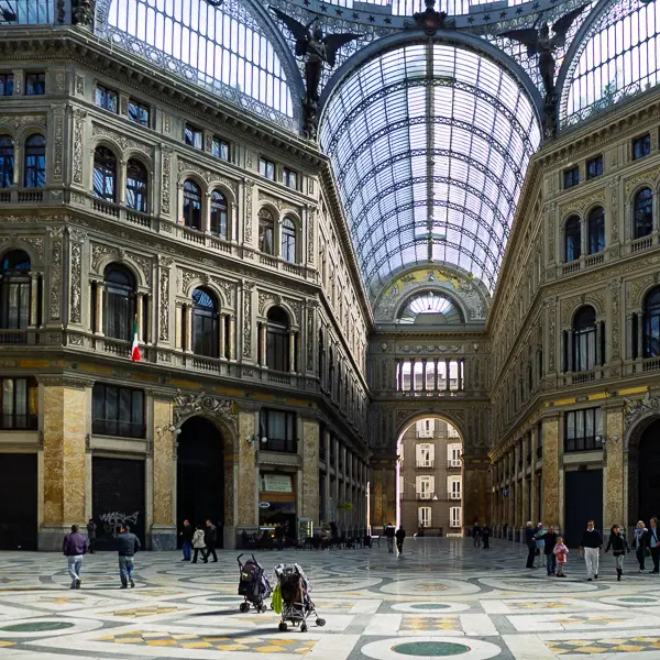 Locals and visitors explore the Galleria Umberto I in Naples, Italy.