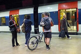 Paris RER Ligne C with bicyclist on platform.