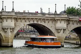 L'INSOLITE passes under a bridge on the River Seine