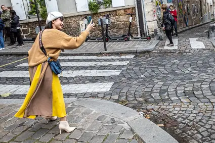 Tourist in Montmartre with smartphone