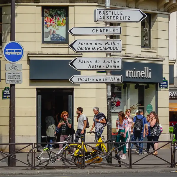 Directional signs compete for attention on the Boulevard Saint-Michel in Paris.