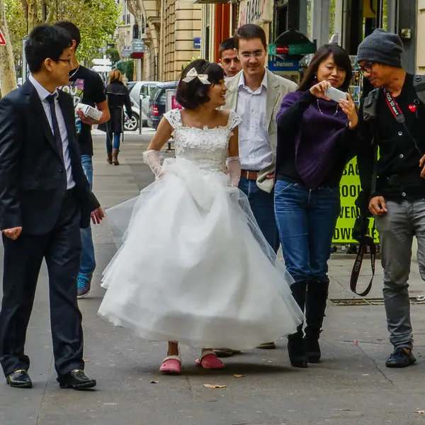 A woman in a bridal outfit heads for a photo shoot near the Eiffel Tower in Paris.