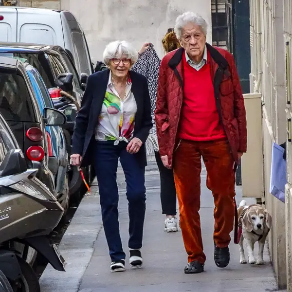 A couple and their dog stroll through Montmartre.