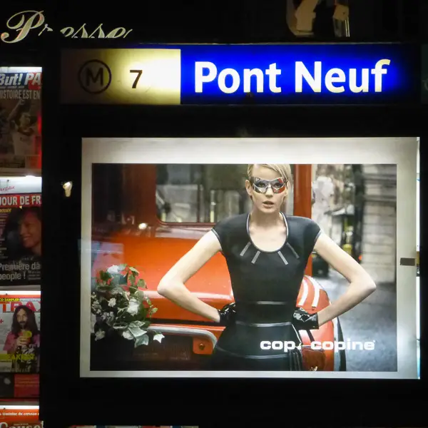 A fashion model poses onscreen at a Metro station in Paris.