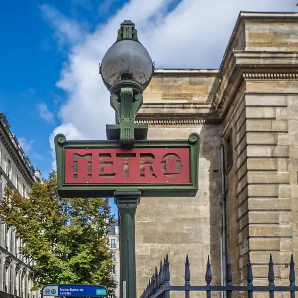 A Paris M�tro sign stands next to the church of Notre Dame de Lorette.