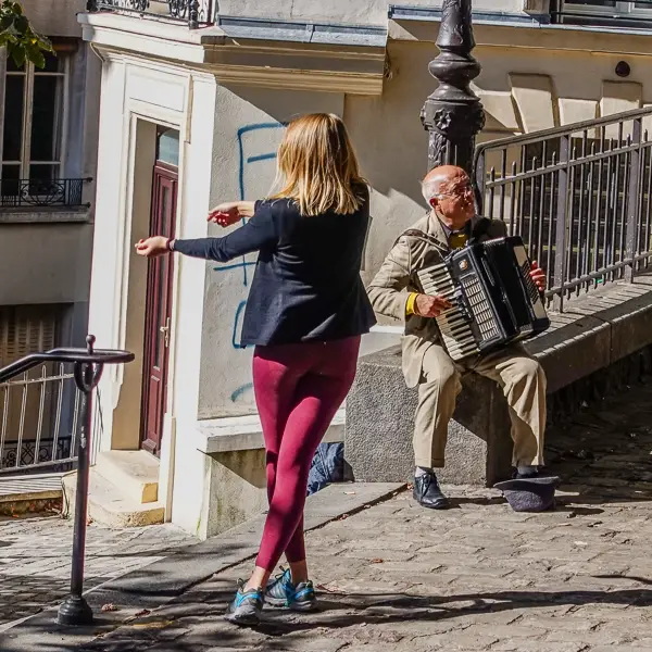 A busker accompanies a dancer in Montmart's Place Emile Goudeau.