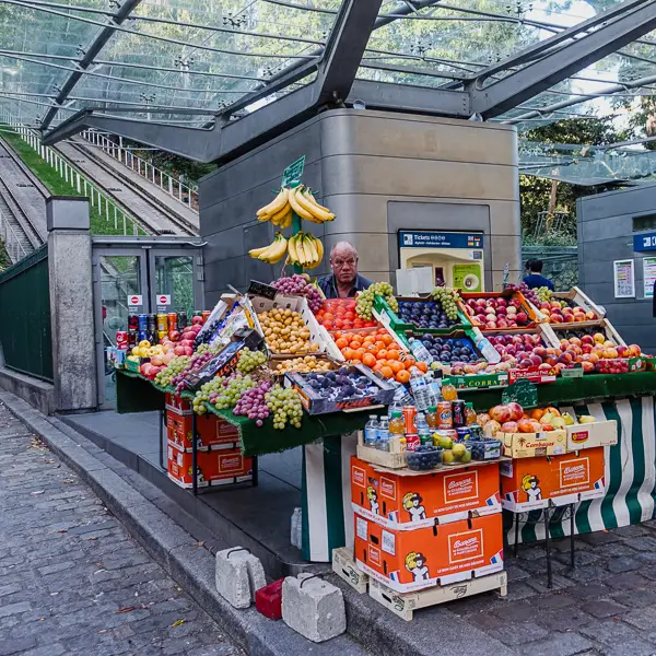A fruit vendor tempts passengers of the Montmartre Funicular.