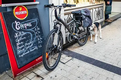 Creperie in Beauvais, France with bicycle and dog