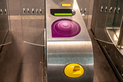 Paris Metro turnstile with ticket slot and Navigo card reader.