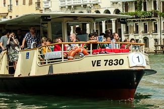 Venice, Italy- July 28,2011: Image Of Il Vaporeto With Tourists Sailing  On The Grand Canal In Venice. Il Vaporeto Is A Motorised Waterbus Which Ply  Regular Routes Along The Major Canals And