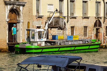 Spazzini with garbage cart and boat in Venice