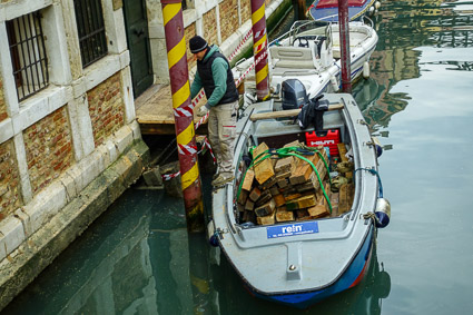 Barge unloading lumber in Venice