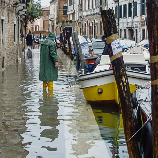 Electricians work on a storefront in Venice's historic center.