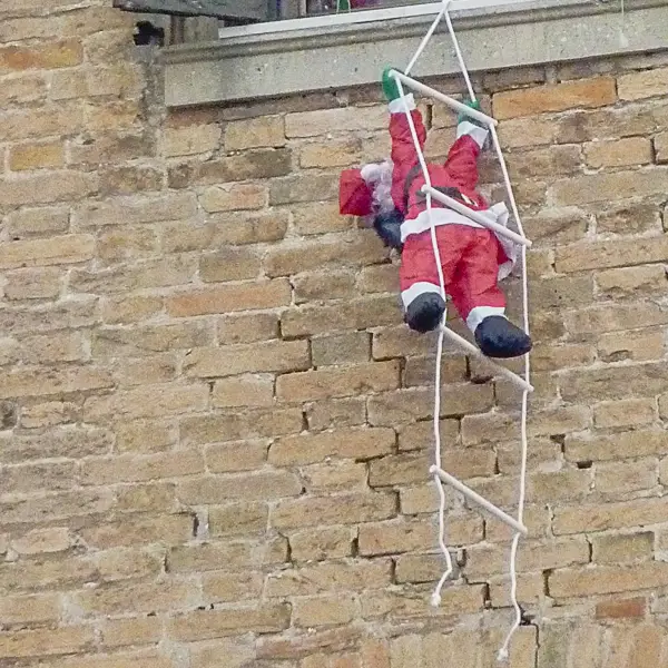Santa climbs a rope ladder in Venice, Italy.