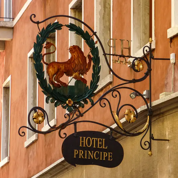 A wingless Lion of St. Mark decorates a sign at the Hotel Principe near Venice's Santa Lucia railroad station.