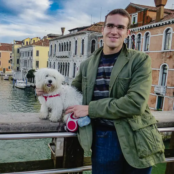 A man poses with his dog on Venice's Accademia Bridge.