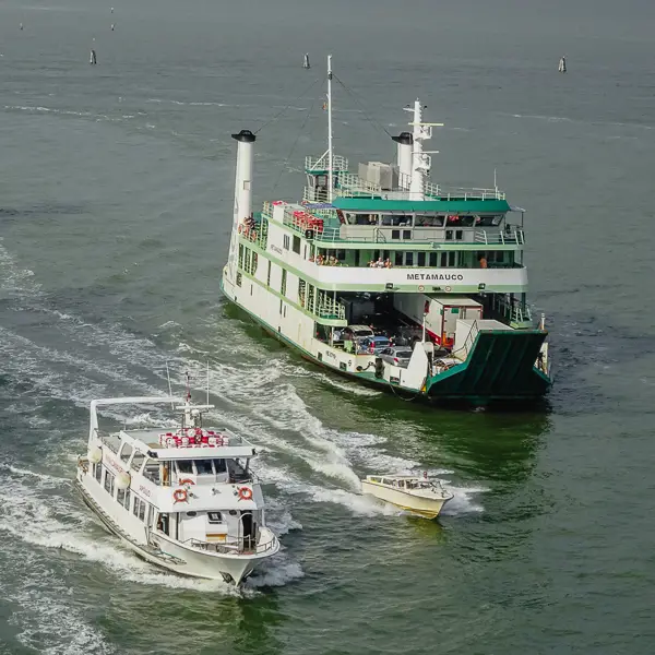 An ACTV Lido car ferry, a water taxi, and a sightseeing boat cruise up Venice's Giudecca Canal.