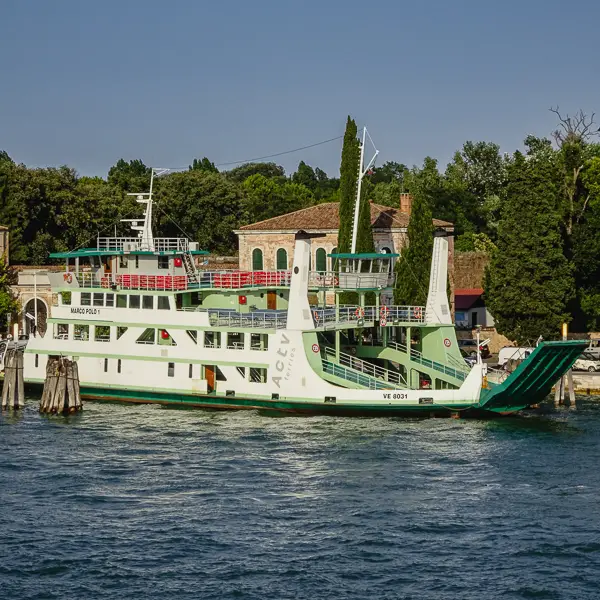  A No. 17 boat discharges cars, motor scooters, bicycles, and foot passengers at the Lido di Venezia's San Nicolò ferry slip.