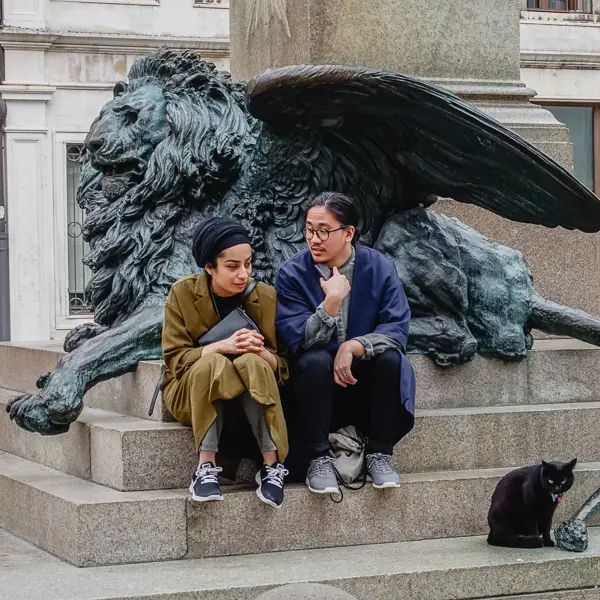 A couple and a cat share a monumental moment.