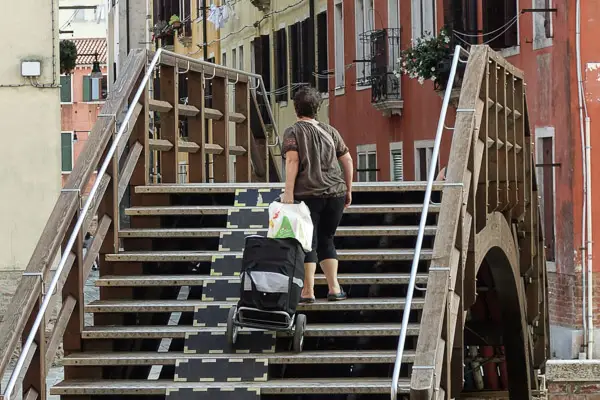 Lady with grocery cart in Venice, Italy.