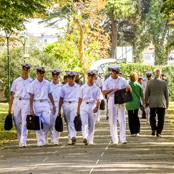Italian Navy cadets from the Francesco Morosini Naval Military School walk through a park on Venice's waterfront.