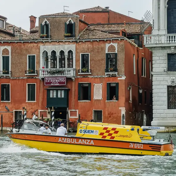 An ambulance passes the Residenza d'Epoca Ca' Favretto on Venice's Grand Canal.